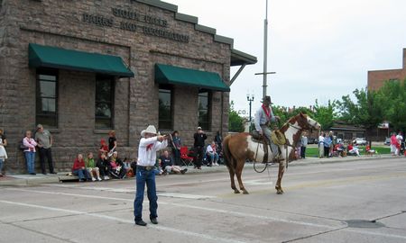 Cowboys demonstrate their ranching and roping skills at the Sioux Falls Fourth of July parade.